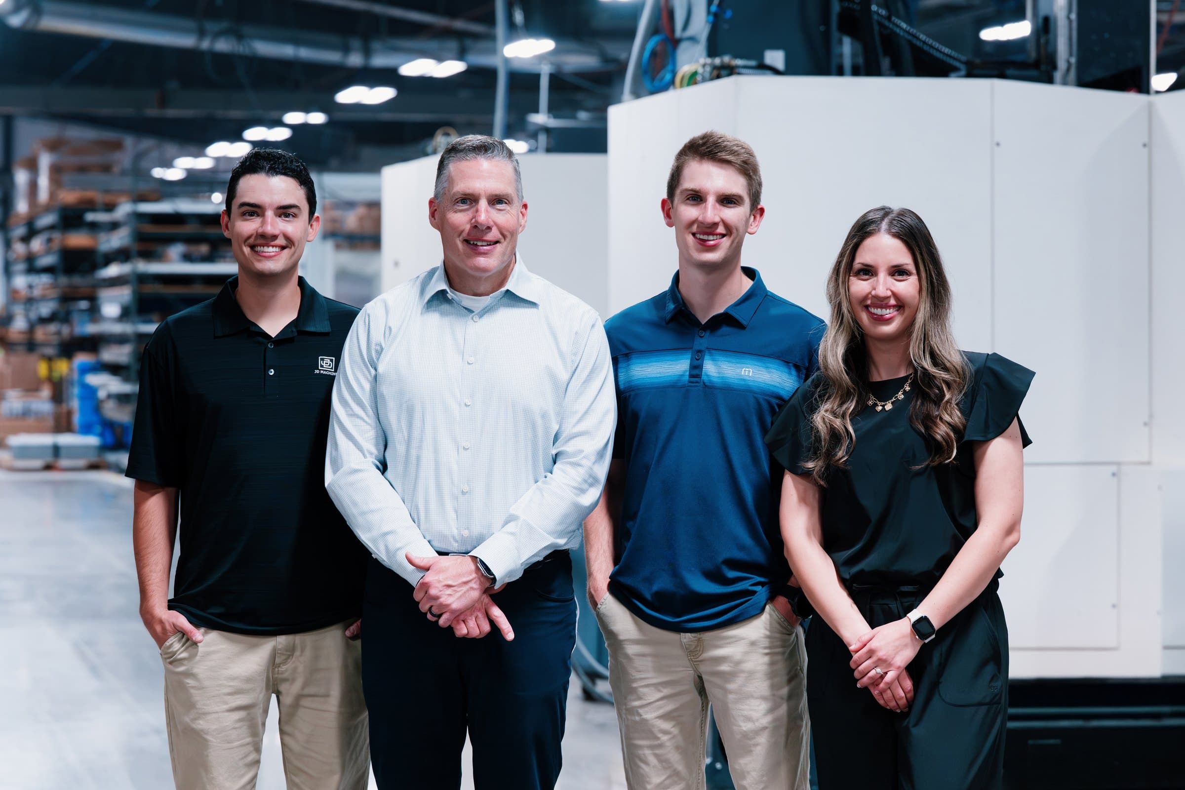 Four members of the Wardle family standing together in the machine shop