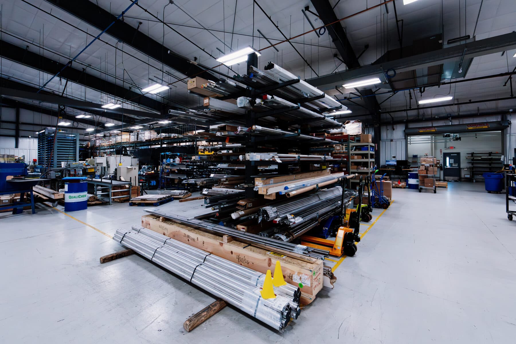 Racks of bar stock and extrusions in the material storage area